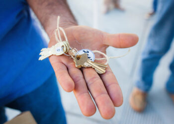 up close photo of keys in a person's hand
